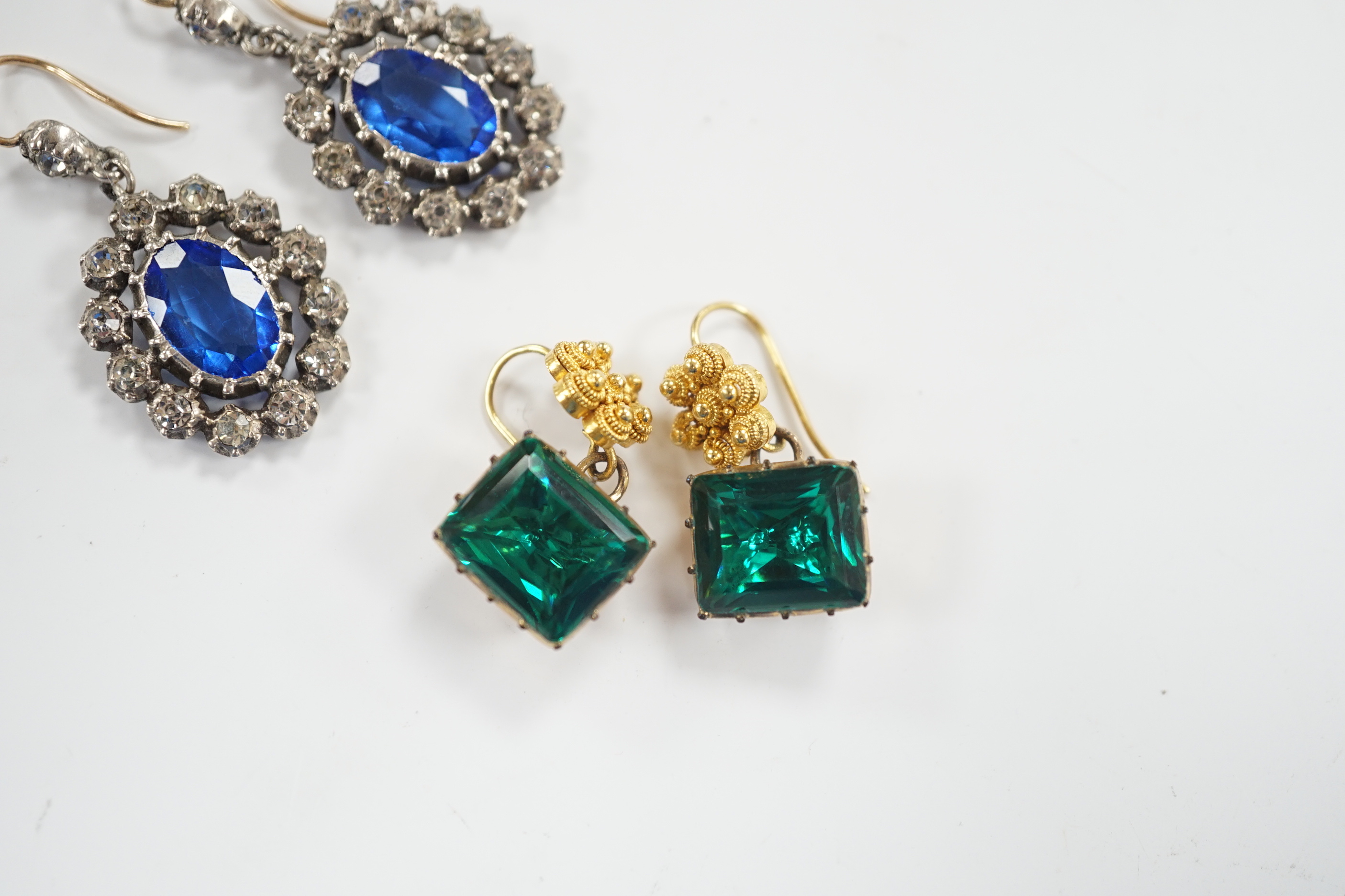 A pair of yellow metal and foil backed green paste set drop earrings, 11mm and a pair of blue and white paste set cluster drop earrings.